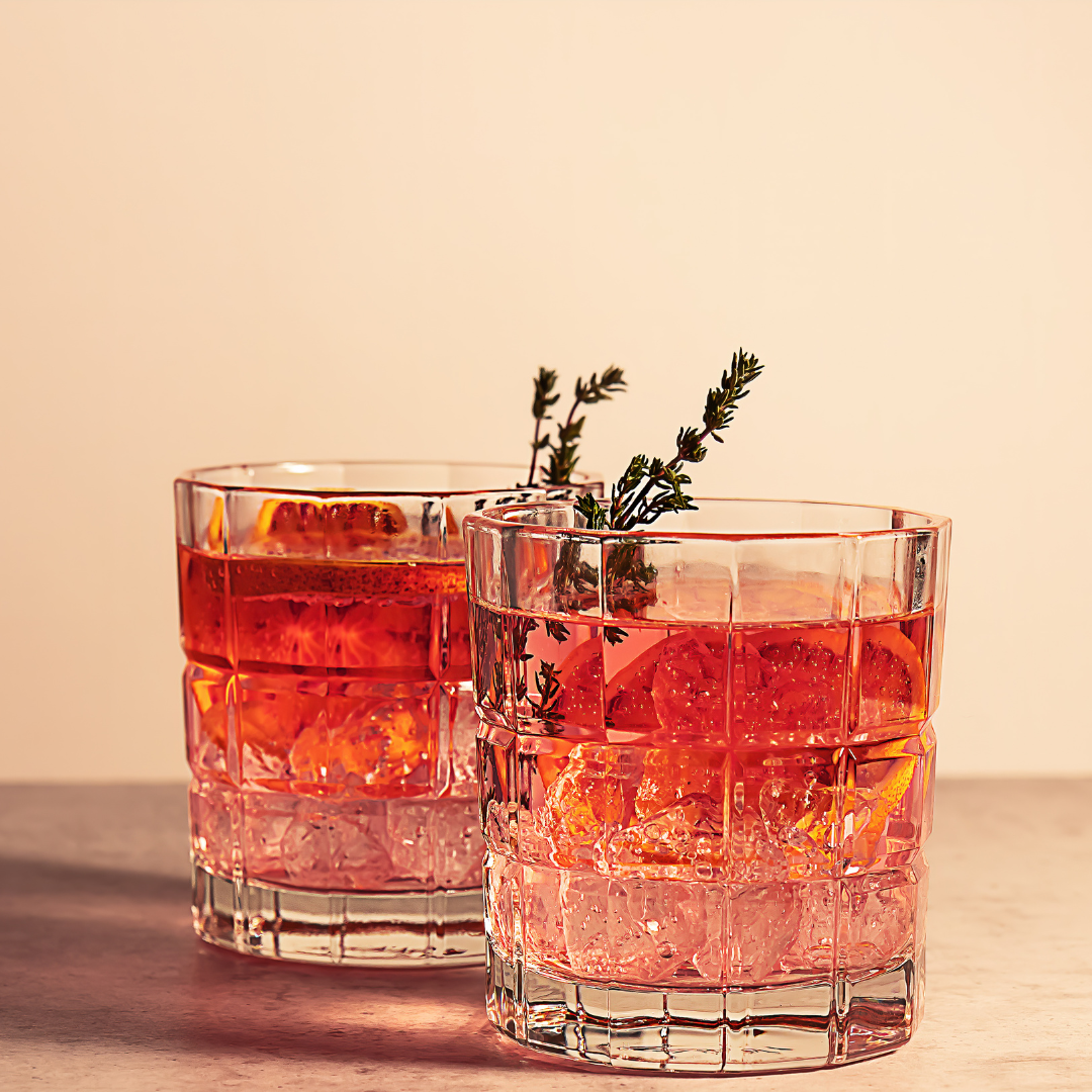 to fancy cocktails in glasses on a table