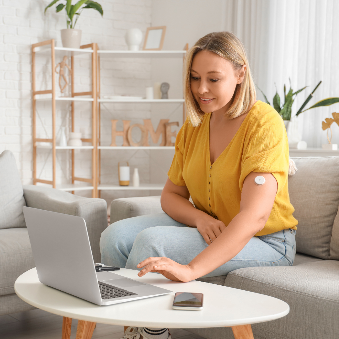 woman working on computer wearing CGM