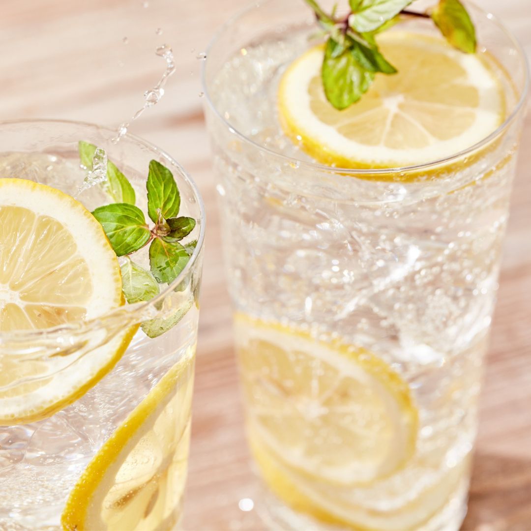 two glasses of sparkling water with lemons