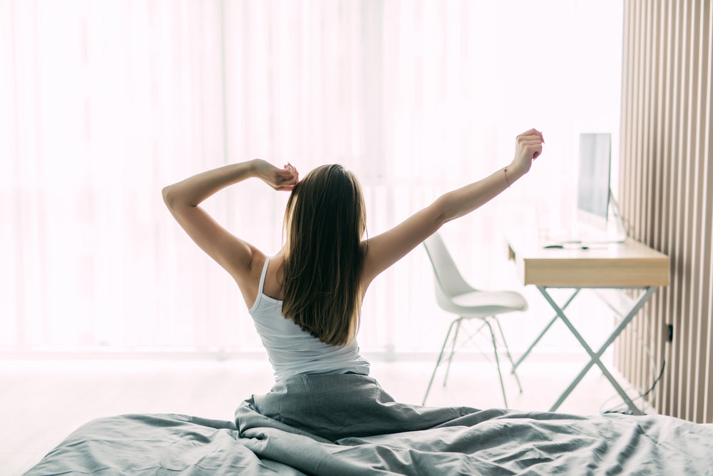 woman-stretching-bed-after-waking-up