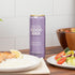 Can of Good Idea sparkling water with a salad and salmon dish on a table.