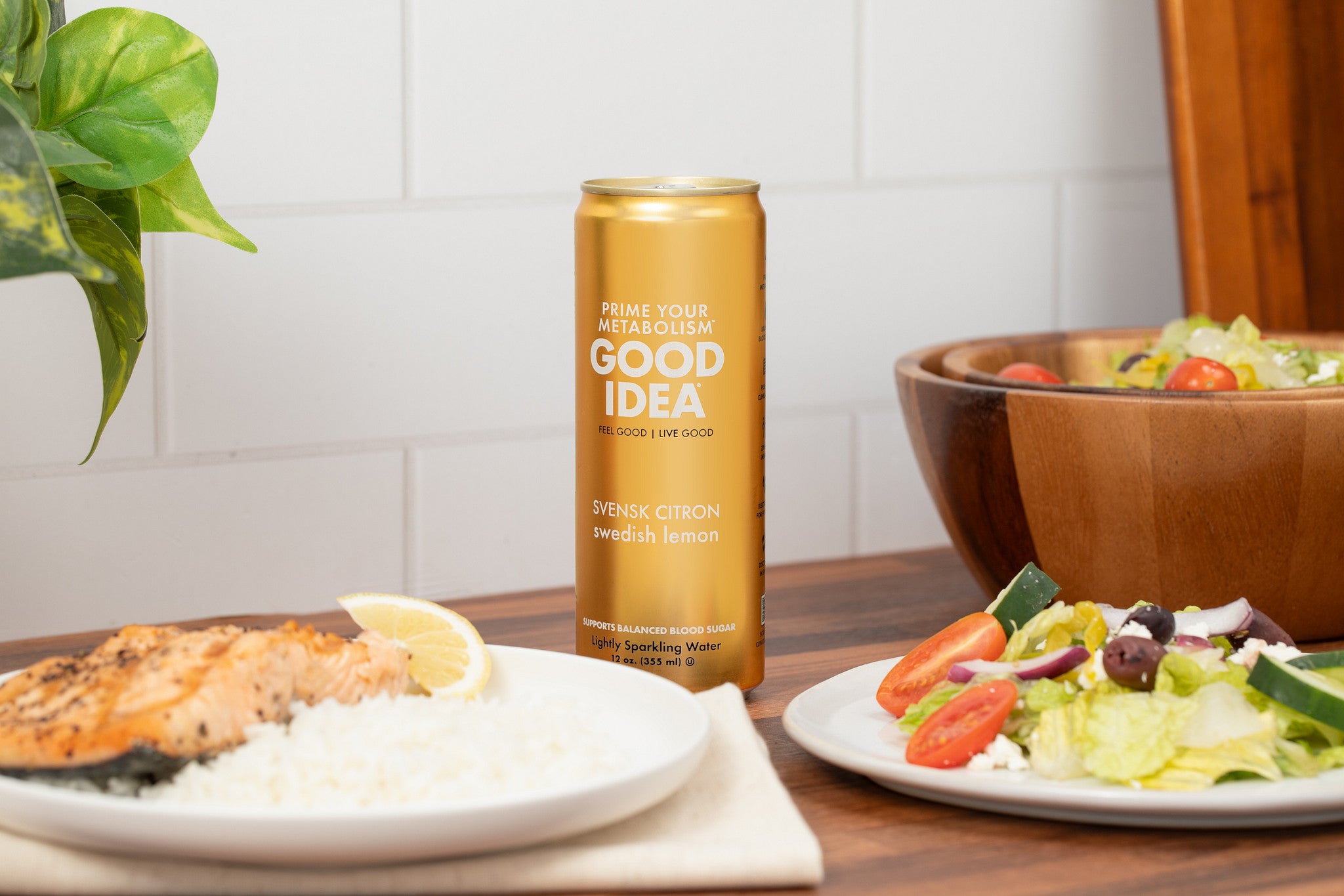 Can of Good Idea in the Swedish Lemon flavor on a table with food including salmon, rice, and salad