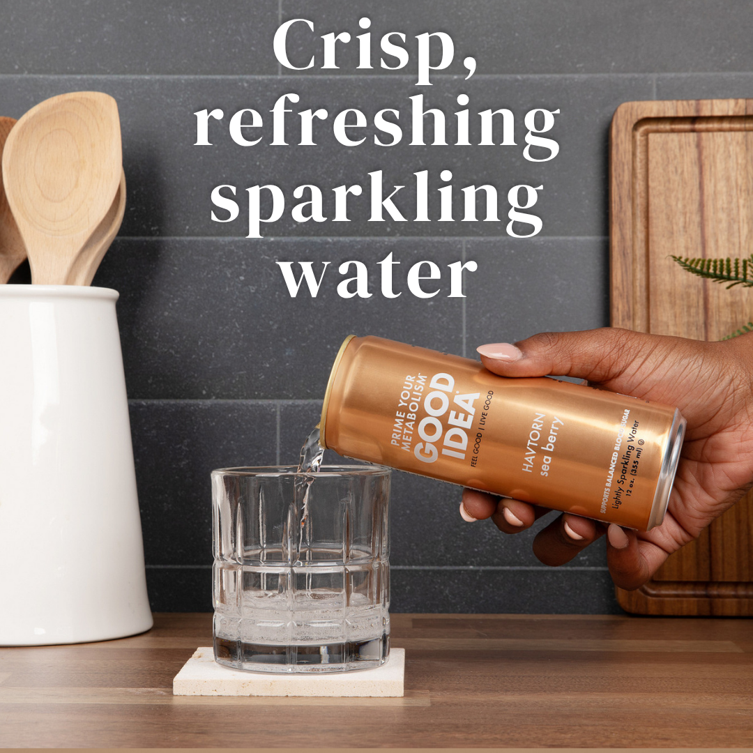 Person pouring a can of GOOD IDEA Sea Berry sparkling water into a glass on a kitchen counter, with text on the image that reads “crisp, refreshing sparkling water.”