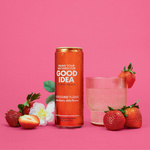 Can of GOOD IDEA Strawberry Elderflower sparkling water with a glass of sparkling water and fresh strawberries beside it.