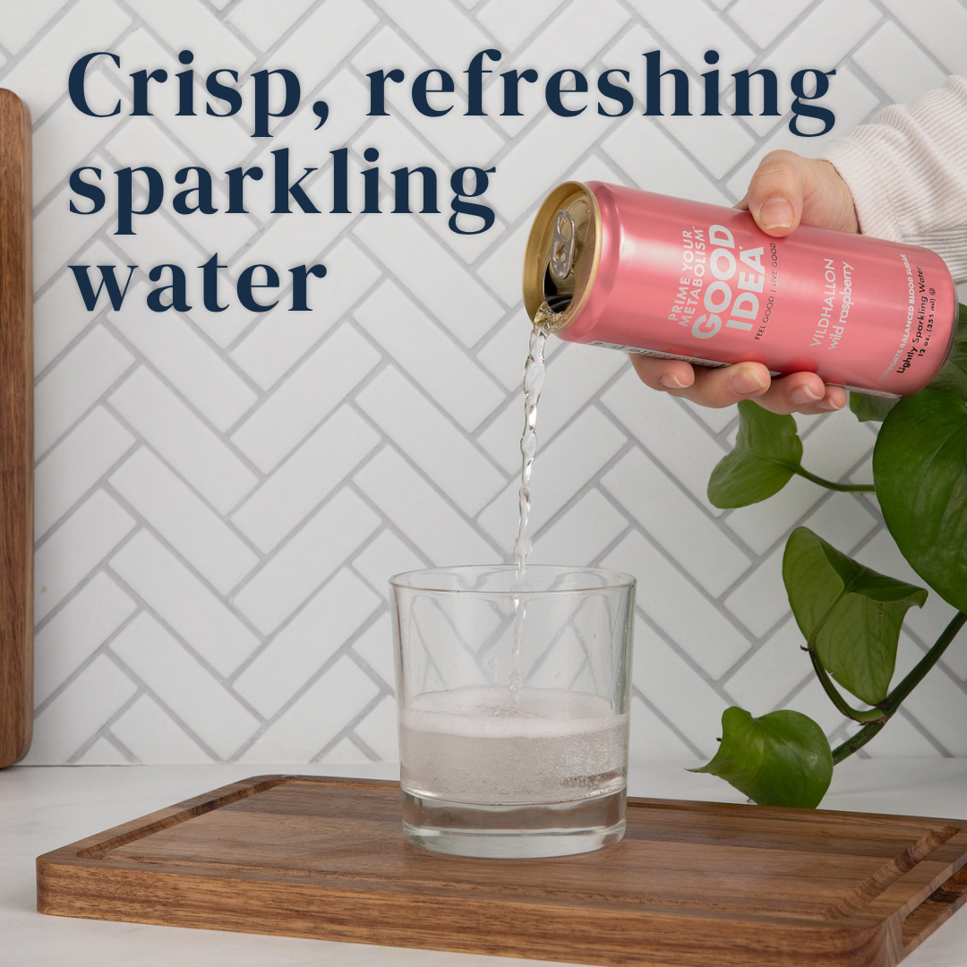 Person pouring a can of GOOD IDEA Wild Raspberry sparkling water into a glass on a kitchen counter, with text on the image that reads “crisp, refreshing sparkling water.”