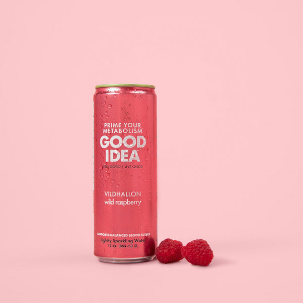 Can of Good Idea Wild Raspberry sparkling water with raspberries on a pink background