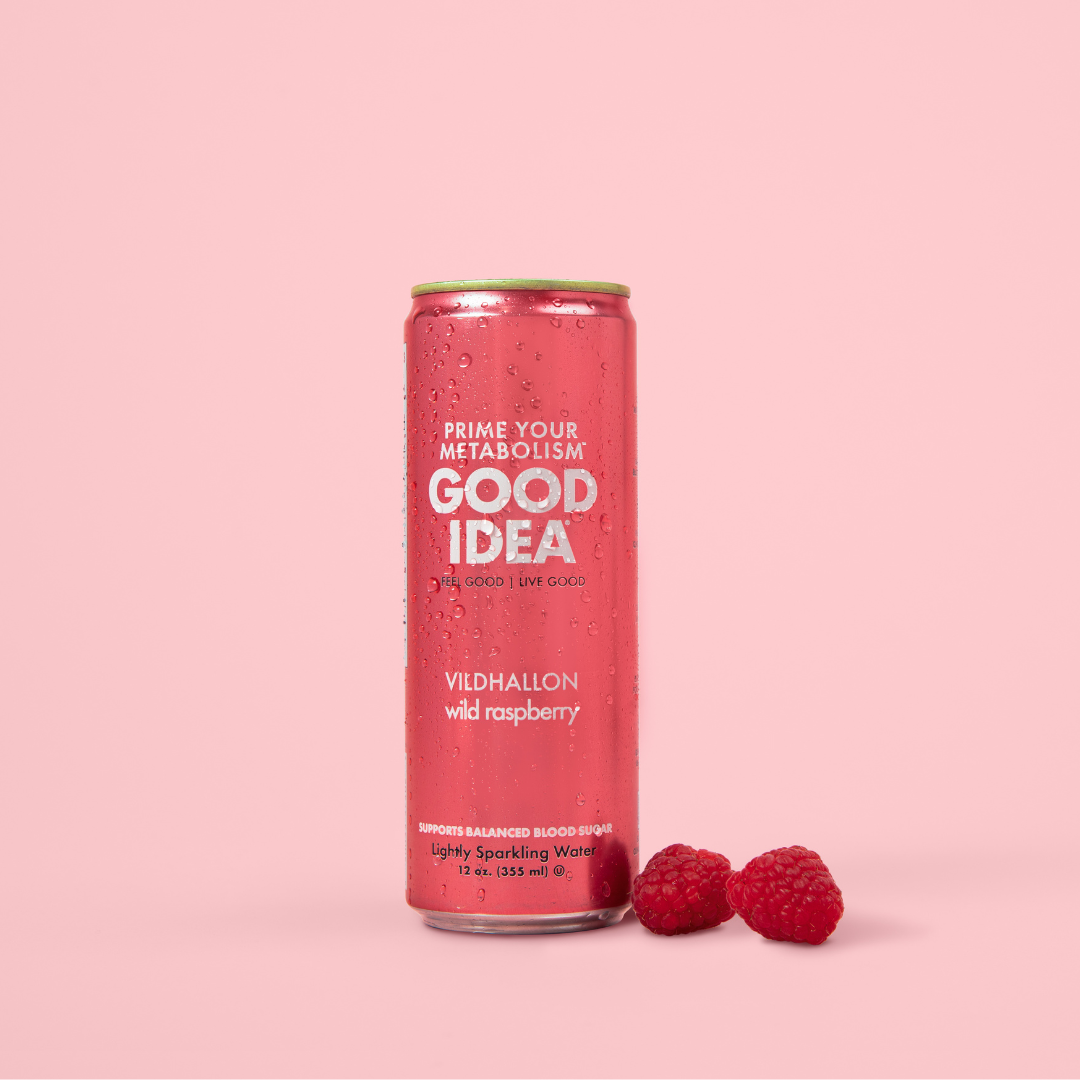 Can of Good Idea Wild Raspberry sparkling water with raspberries on a pink background